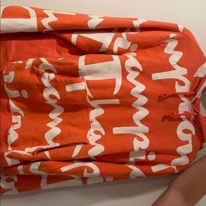 A lightly used orange champion hoodie